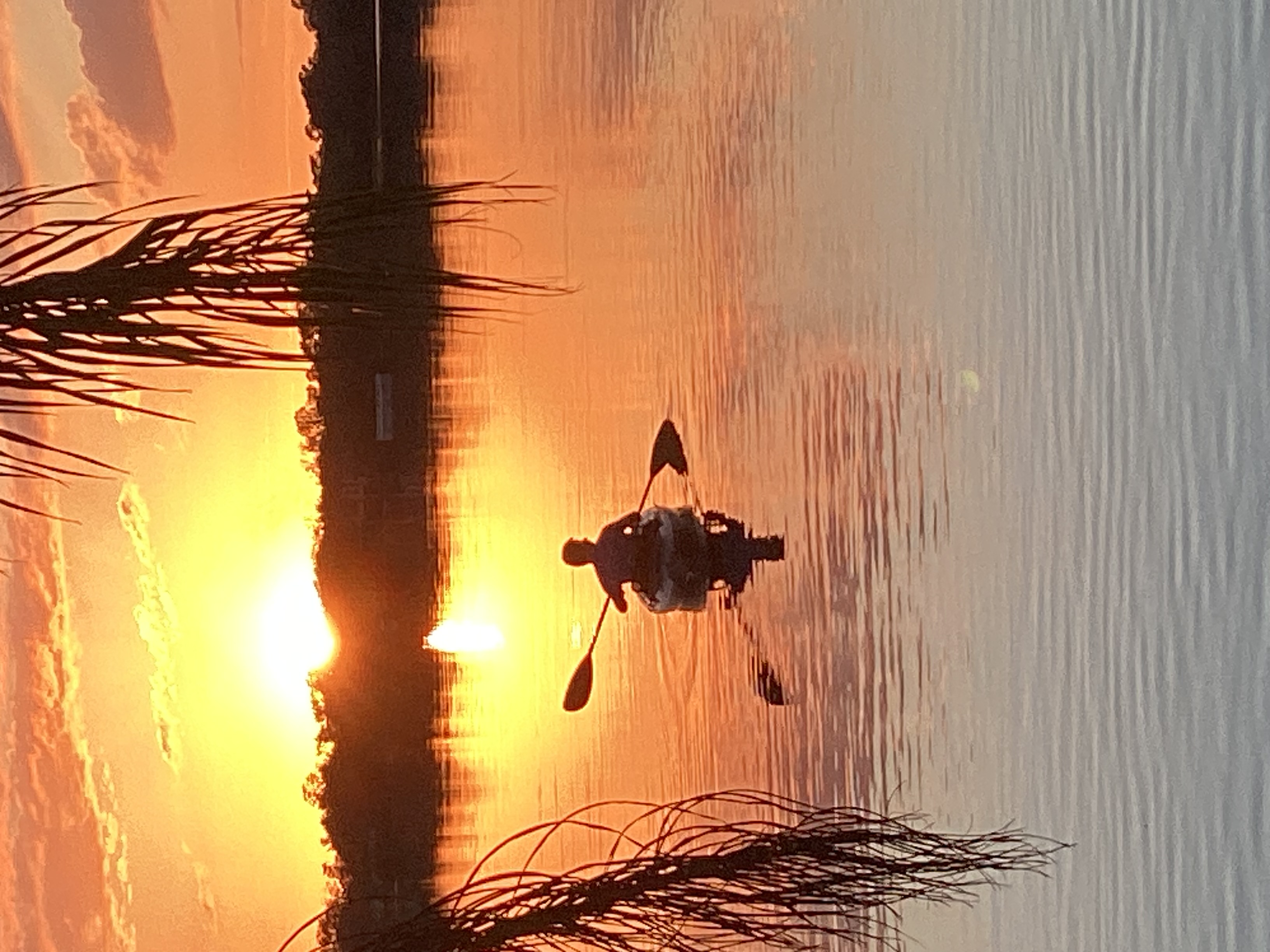 Zach in a kayak at sunset.